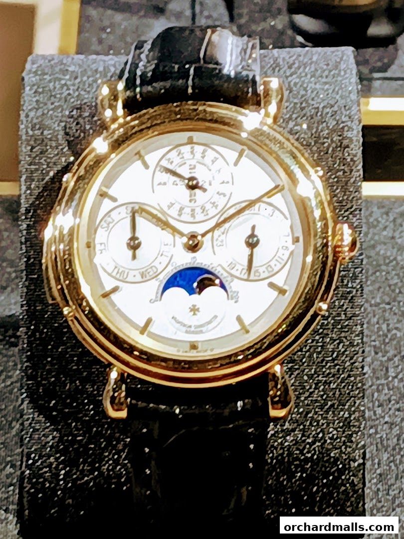 A close-up of a luxurious Vacheron Constantin watch with a gold case and black leather strap.