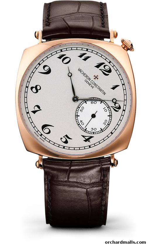 A close-up of a Vacheron Constantin rose gold watch with a white dial and brown alligator strap.