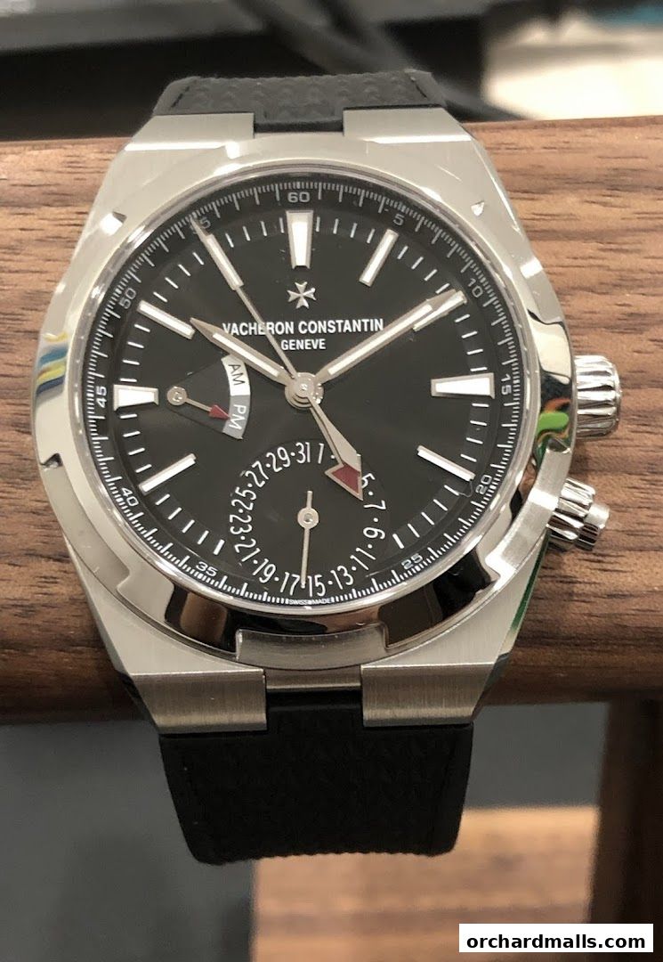 A close-up shot of a Vacheron Constantin watch with a black dial and silver casing.