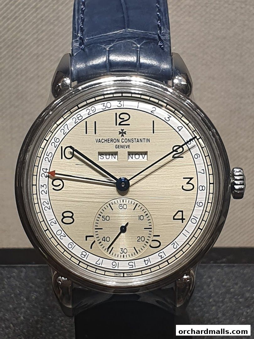 A close-up of a Vacheron Constantin watch with a silver dial and blue leather strap.