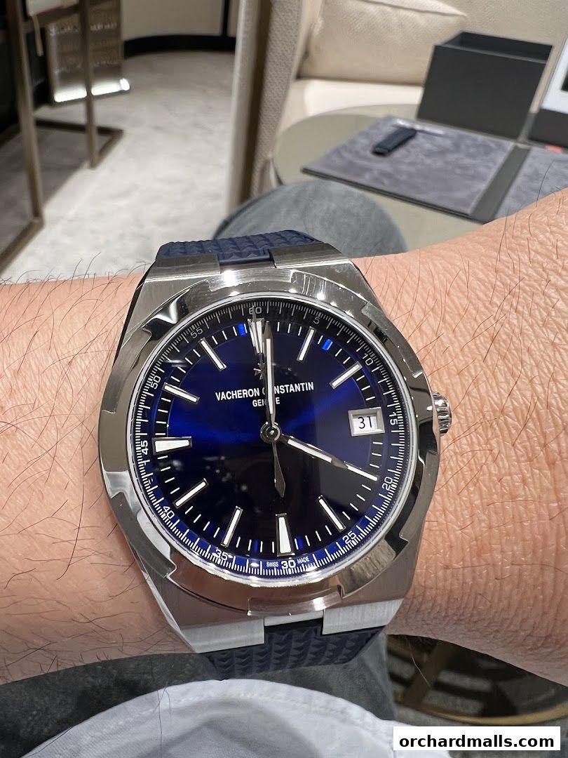 A close-up of a Vacheron Constantin watch with a blue dial on a person's wrist.