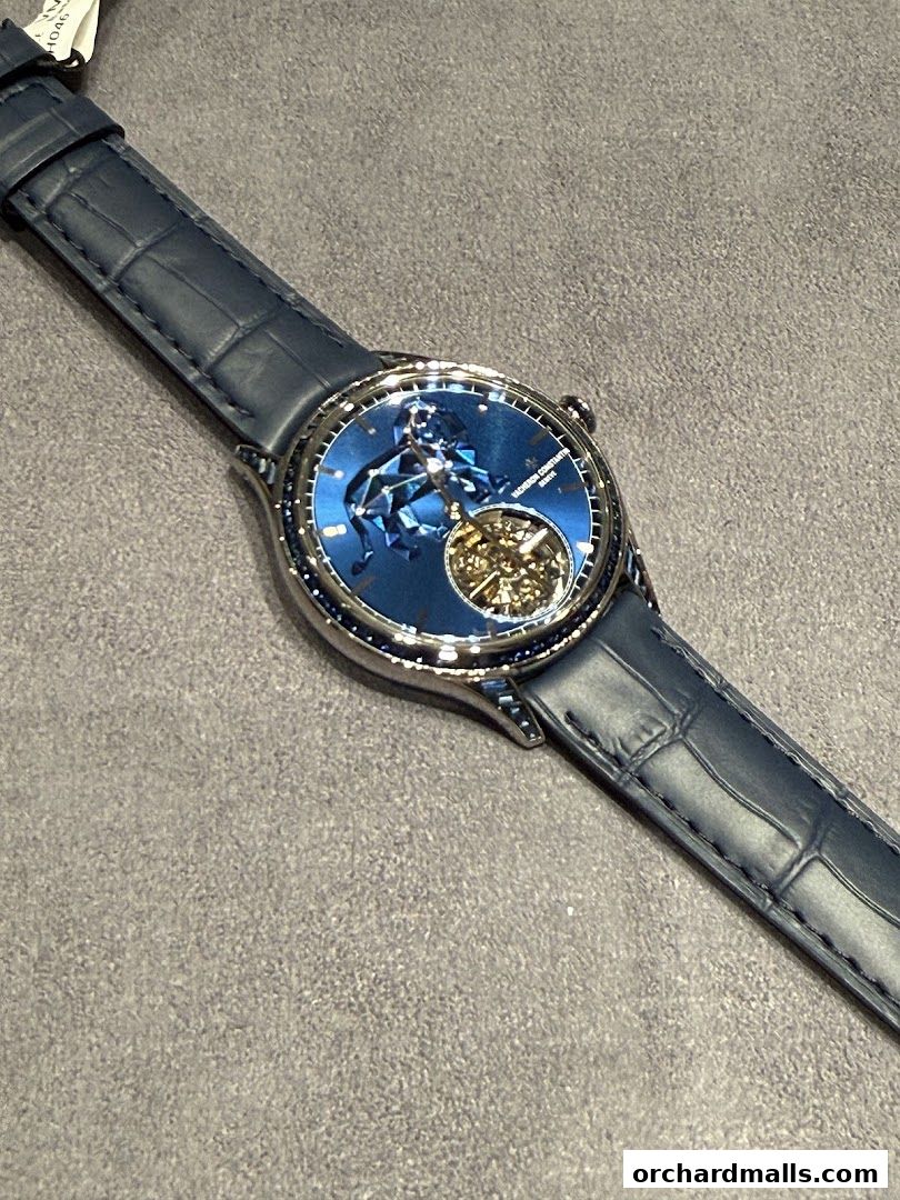 A close-up shot of a luxurious Vacheron Constantin watch with a blue dial and leather strap.
