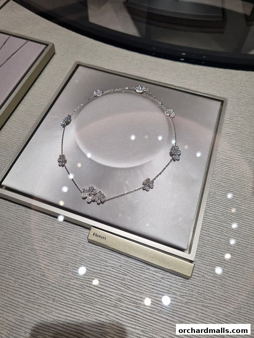 A diamond flower necklace displayed in a jewelry store window.