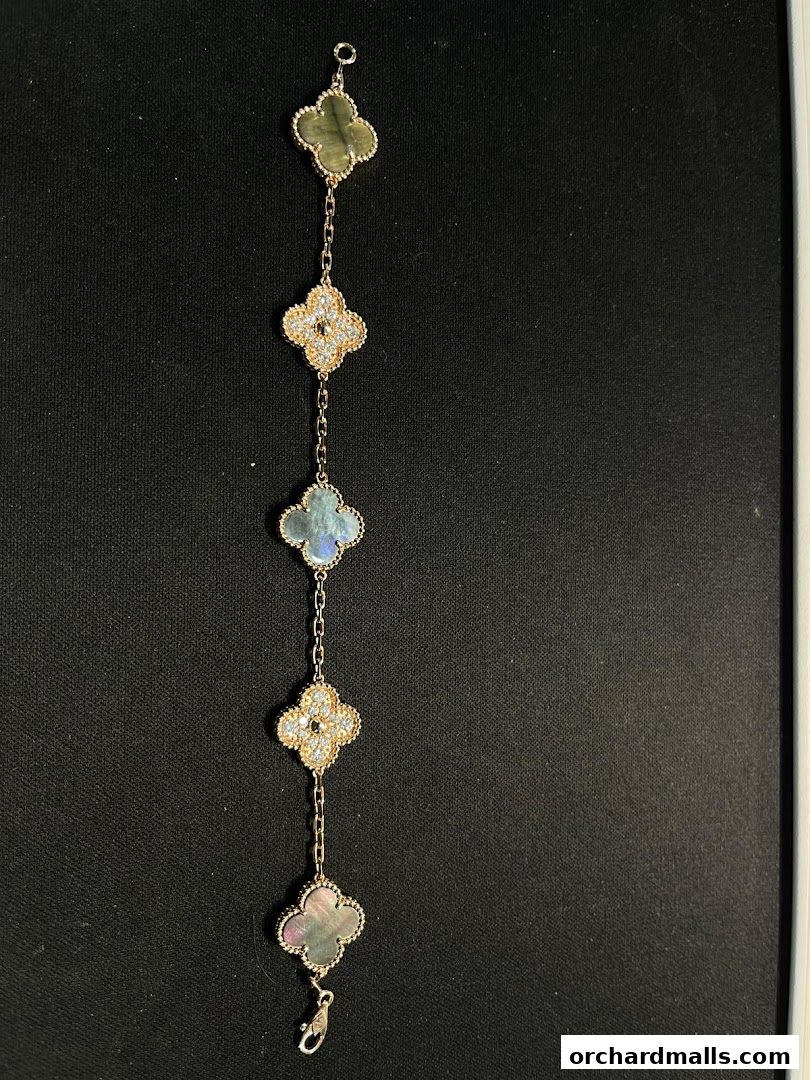 A delicate Van Cleef & Arpels bracelet with clover motifs and gemstones.