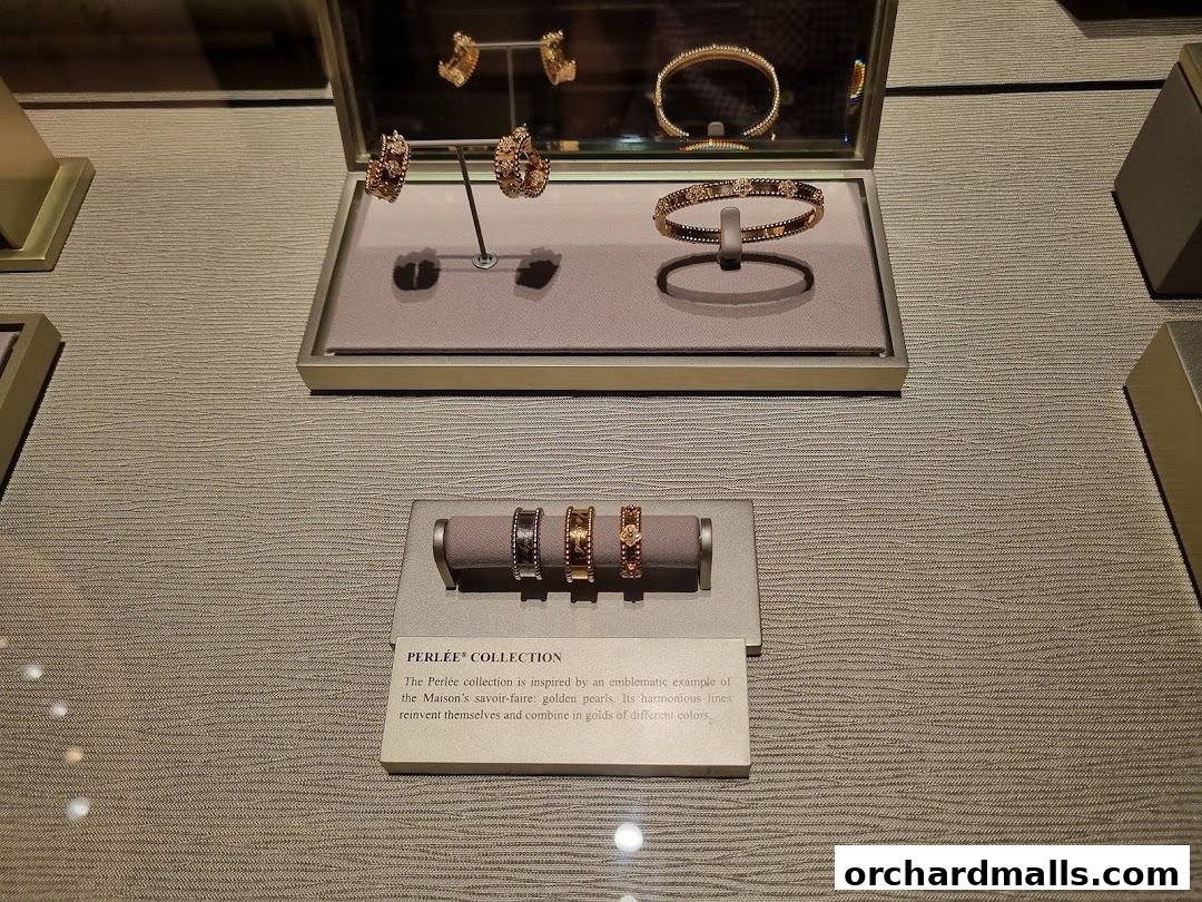 A display of Van Cleef & Arpels jewelry, including earrings, bracelets, and rings.