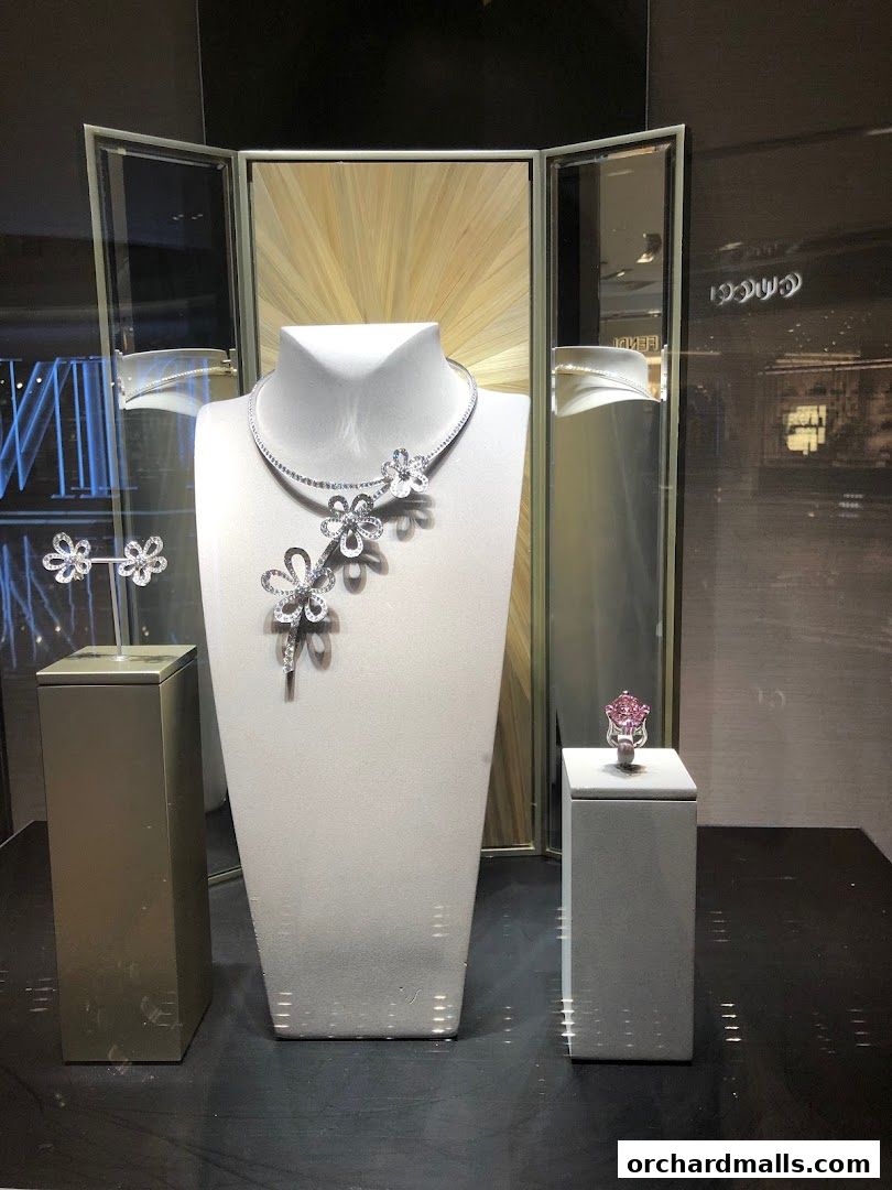 A display window showcasing exquisite diamond jewelry, including a necklace, earrings, and rings.
