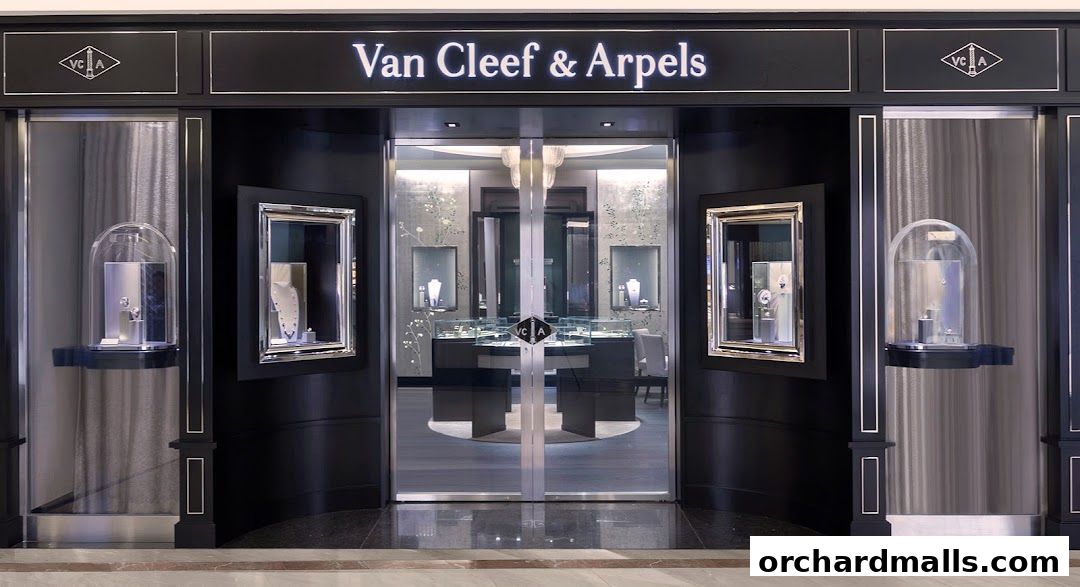 The elegant storefront of Van Cleef & Arpels, showcasing exquisite jewelry in display cases.