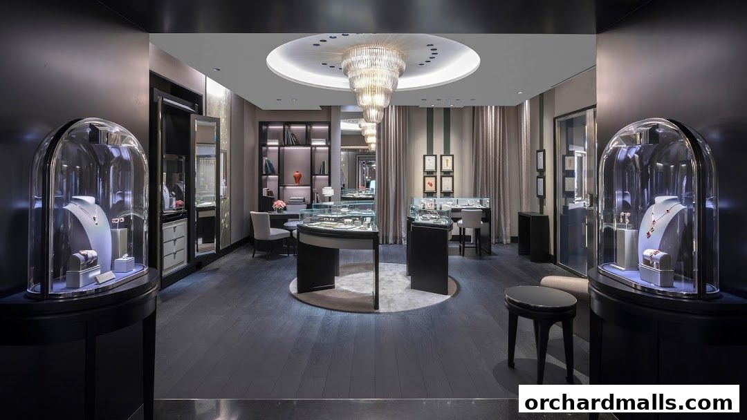 Luxurious interior of a Van Cleef & Arpels boutique with display cases and a chandelier.