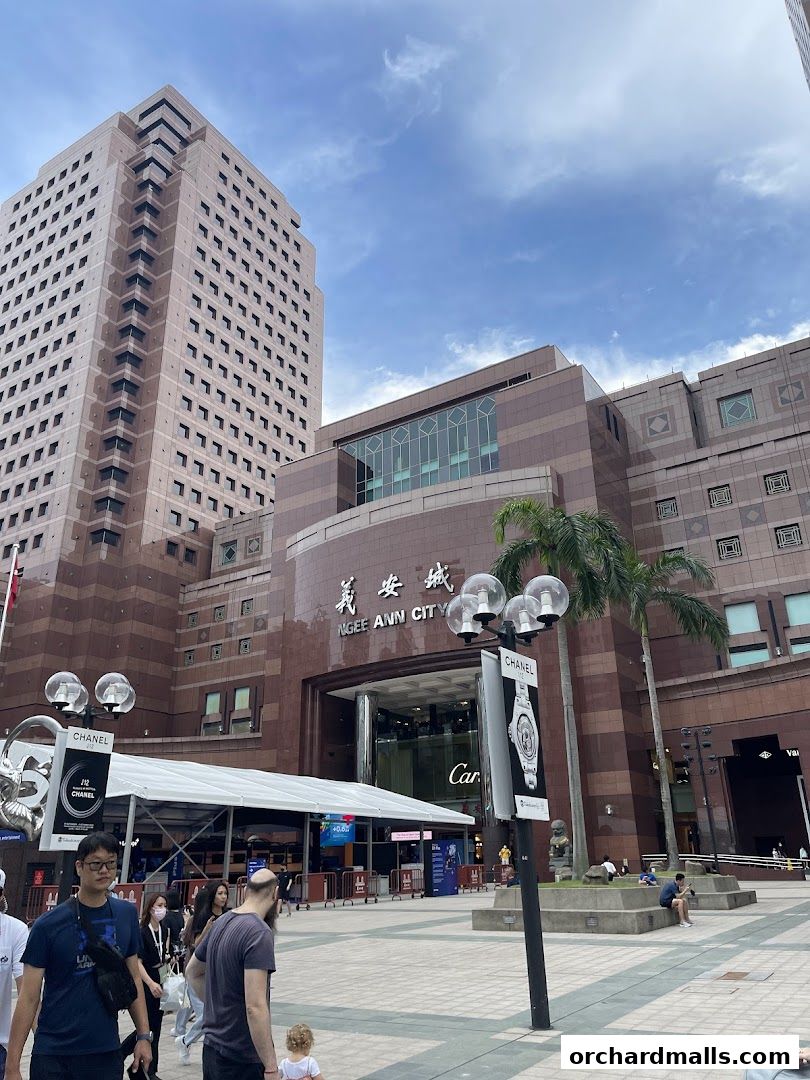 Exterior view of Ngee Ann City shopping mall with a Van Cleef & Arpels store entrance.