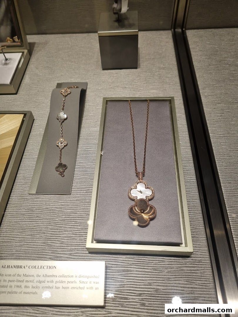 Van Cleef & Arpels Alhambra collection jewelry displayed in a shop window.