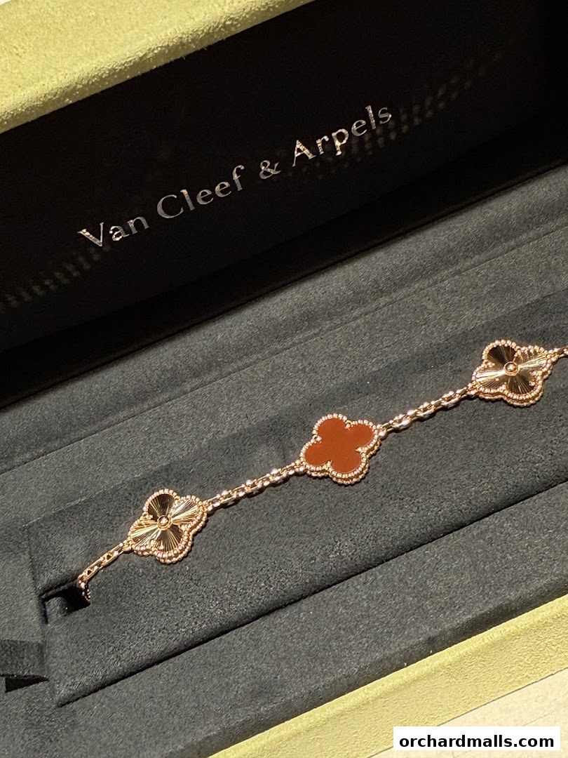 A Van Cleef & Arpels bracelet with clover motifs in a display box.