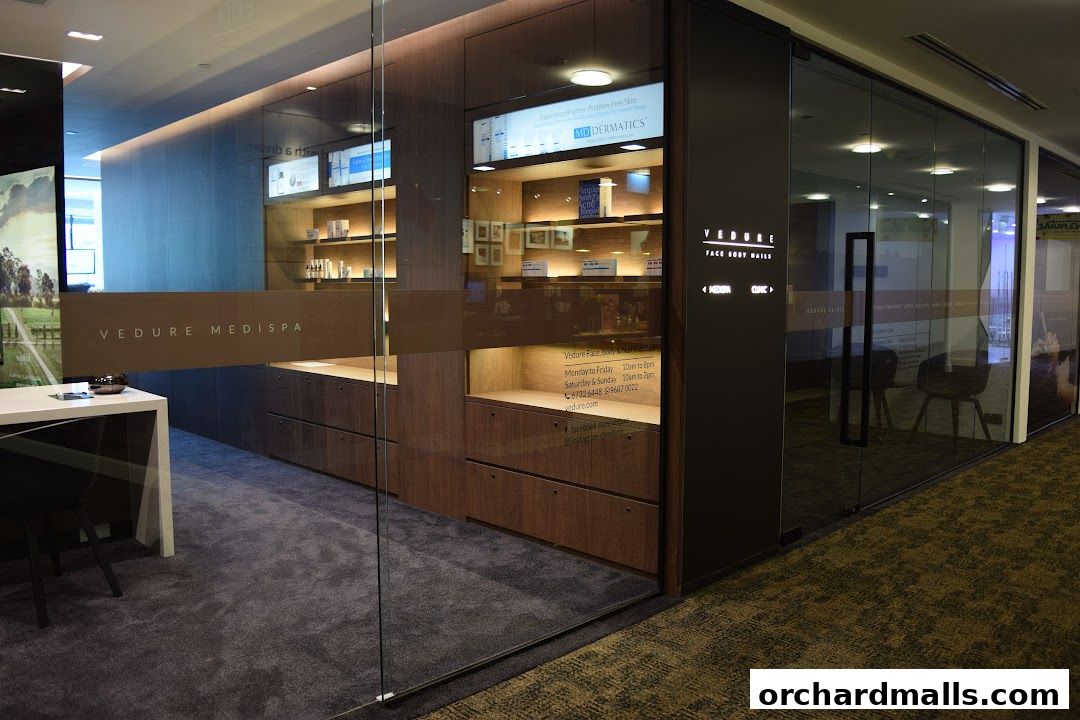 The entrance of Vedure Face, Body & Nail MediSpa, showcasing its modern interior and branding.