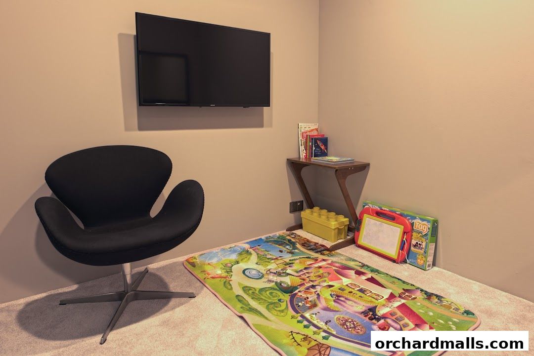 A comfortable waiting area with a black chair, TV, and children's play items.