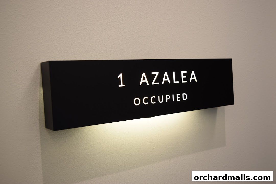 A black sign with white text reading '1 AZALEA OCCUPIED' is illuminated from below.
