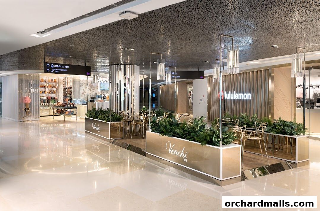 Interior view of Venchi and Lululemon stores with seating areas and plants.