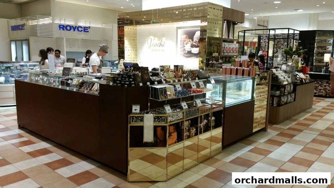 A Venchi chocolate shop display with various chocolates and ice cream.
