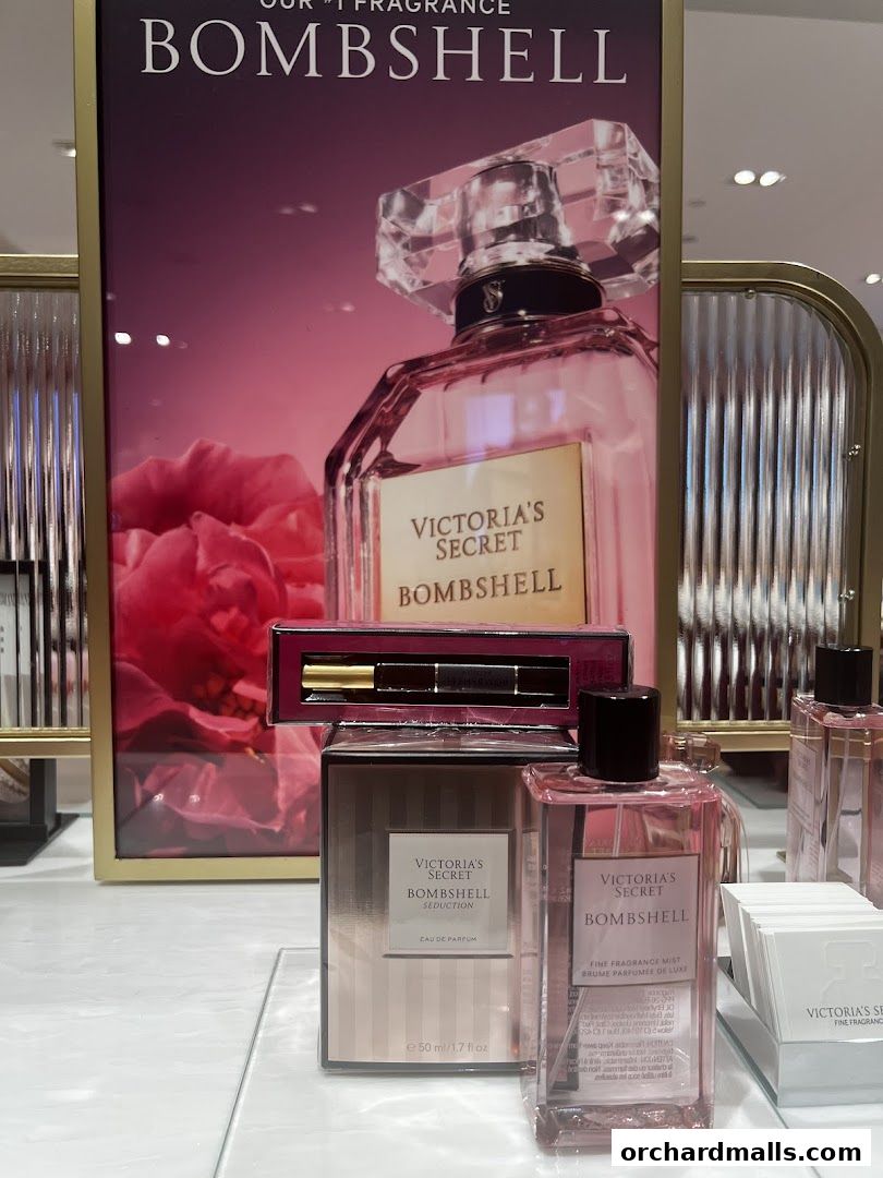 Victoria's Secret Bombshell fragrance products displayed with promotional signage.