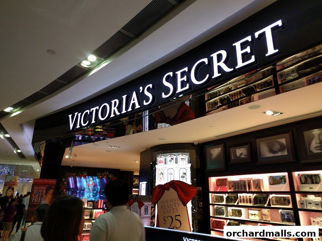 The illuminated Victoria's Secret sign above a display of beauty products and gifts.