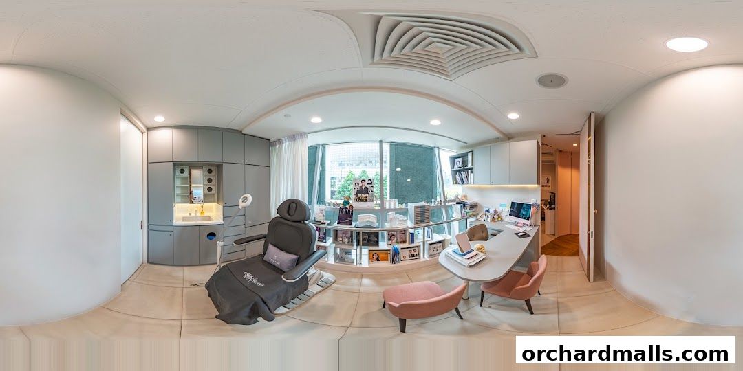 Interior of a modern medical aesthetic clinic with a treatment chair and consultation desk.