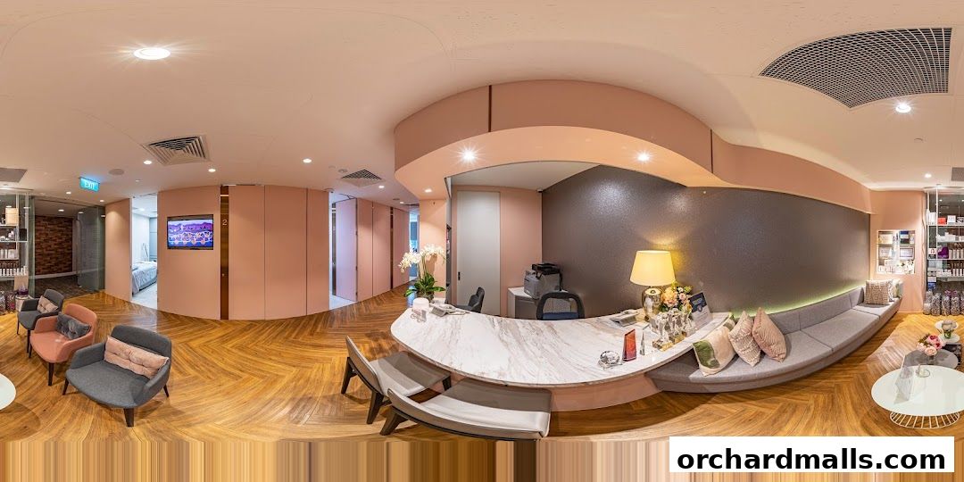 Interior of a modern medical aesthetic clinic with a reception desk and waiting area.