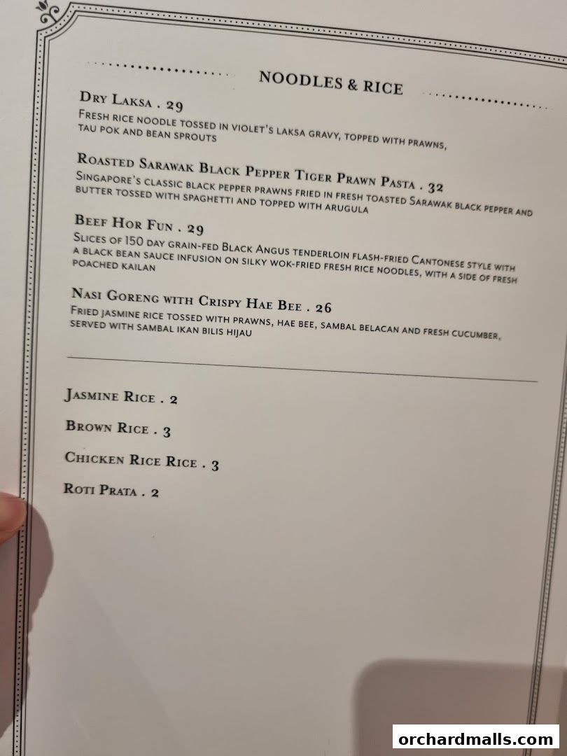 A menu page from Violet Oon at ION Orchard featuring noodles, rice, and side dishes.