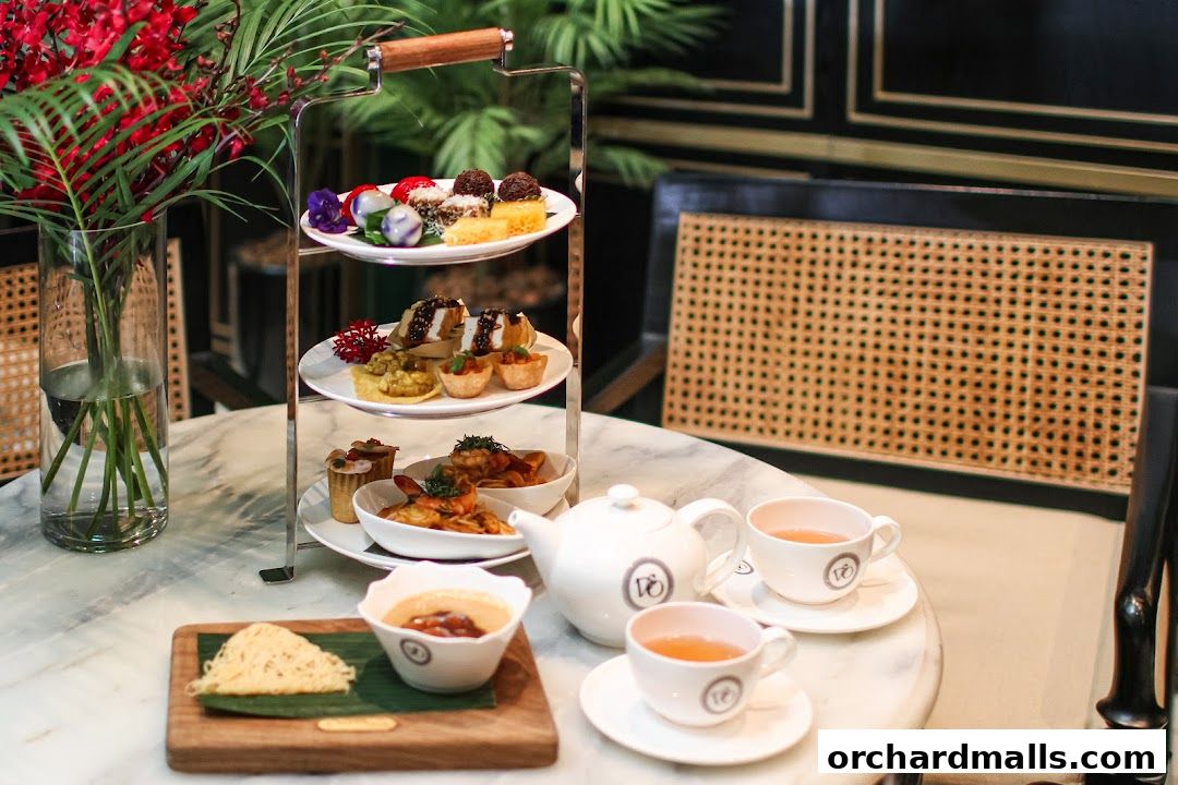 A tiered stand of assorted pastries and savory bites, served with tea.
