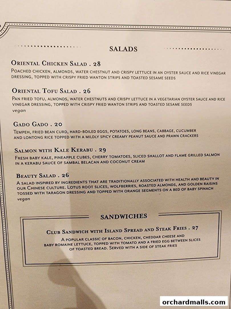 A menu featuring salads and sandwiches with detailed descriptions and prices.