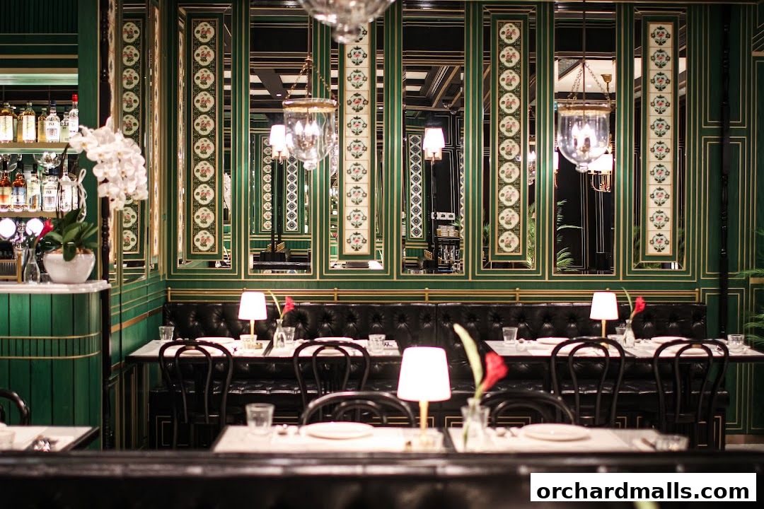 Elegant dining interior with plush seating, ornate mirrors, and ambient lighting.