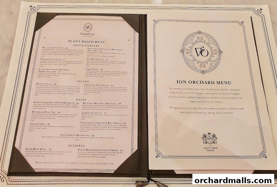 A menu from Violet Oon at ION Orchard featuring plant-based dishes, soups, starters, salads, mains, and desserts.