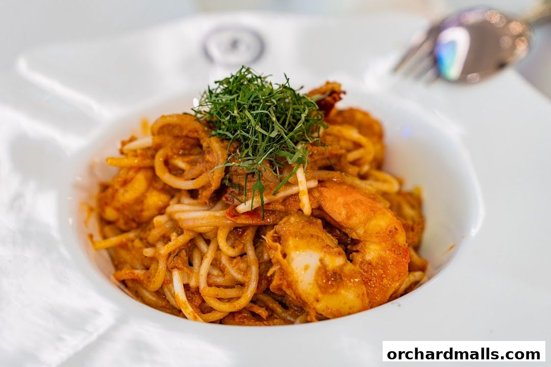 A close-up shot of a delicious seafood pasta dish with prawns and a rich sauce.