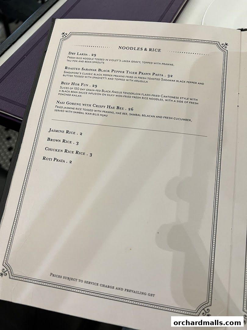 A menu from Violet Oon at ION Orchard featuring noodles, rice, and side dishes.