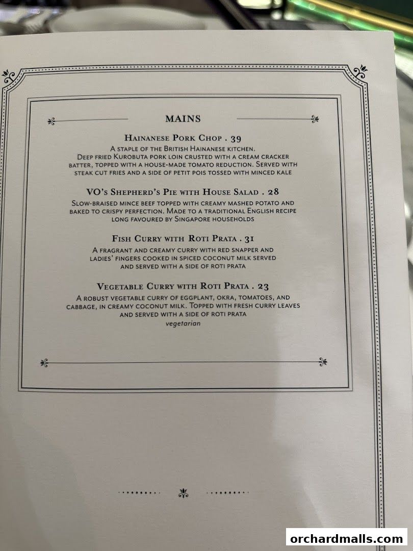 A menu from Violet Oon at ION Orchard featuring mains like Hainanese Pork Chop and Fish Curry.
