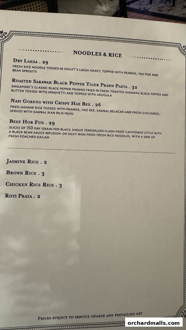 A menu from Violet Oon at ION Orchard featuring noodles, rice, and side dishes.