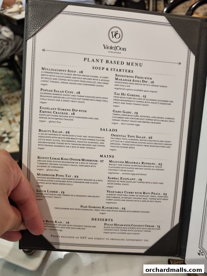 A plant-based menu from Violet Oon at ION Orchard, featuring soups, starters, mains, and desserts.