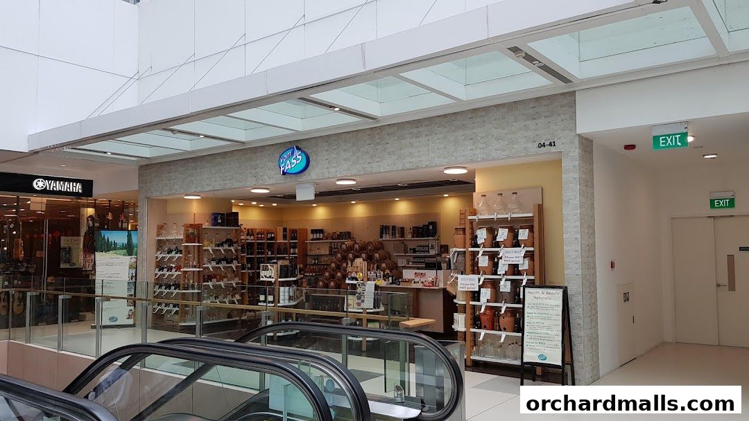 The Vom Fass ION shop front displays a variety of bottles and barrels, showcasing its products.