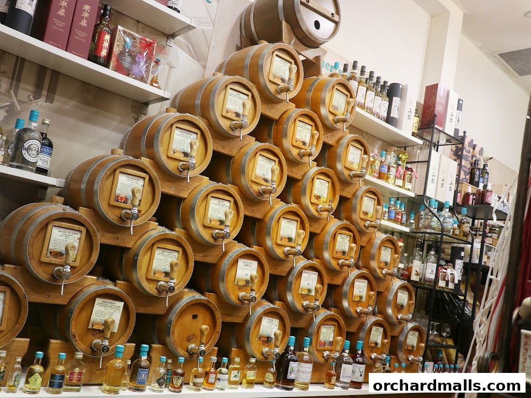 A wall display of wooden barrels with taps, showcasing various spirits and liquors.