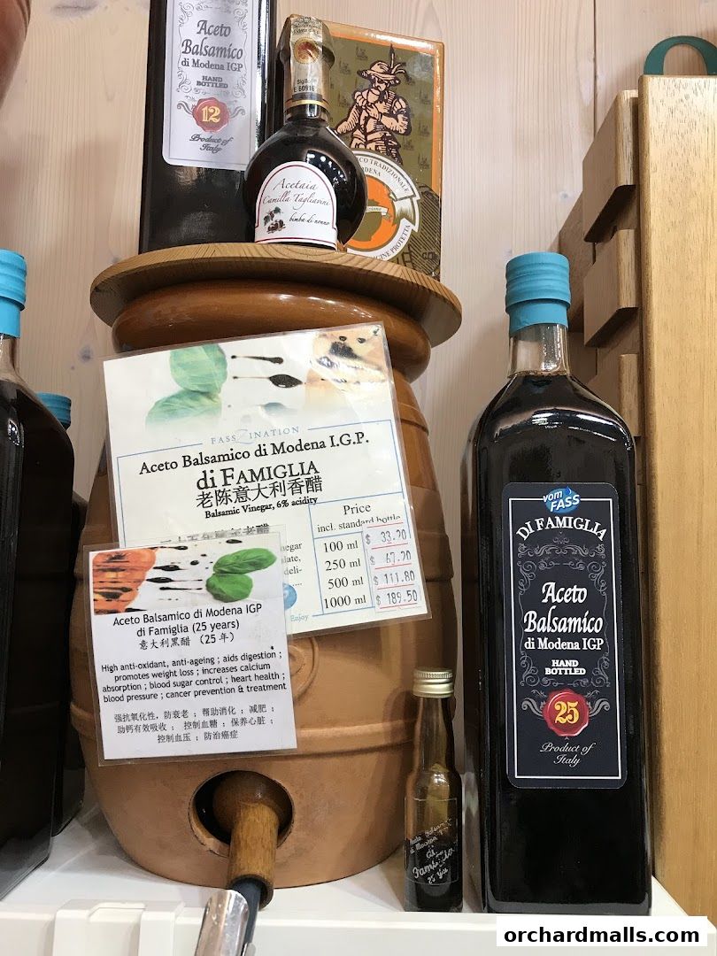 Bottles of Aceto Balsamico di Modena IGP are displayed with product information.