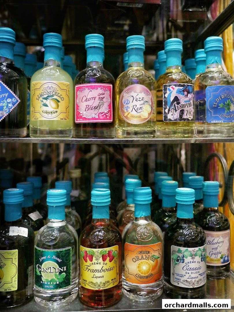 A display of small liqueur bottles with various fruit flavors and unique labels.
