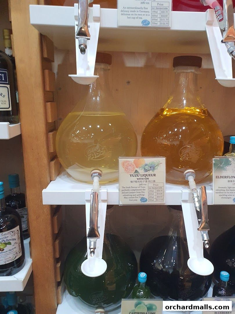 A display of various liqueurs and spirits in large glass bottles with dispensers.