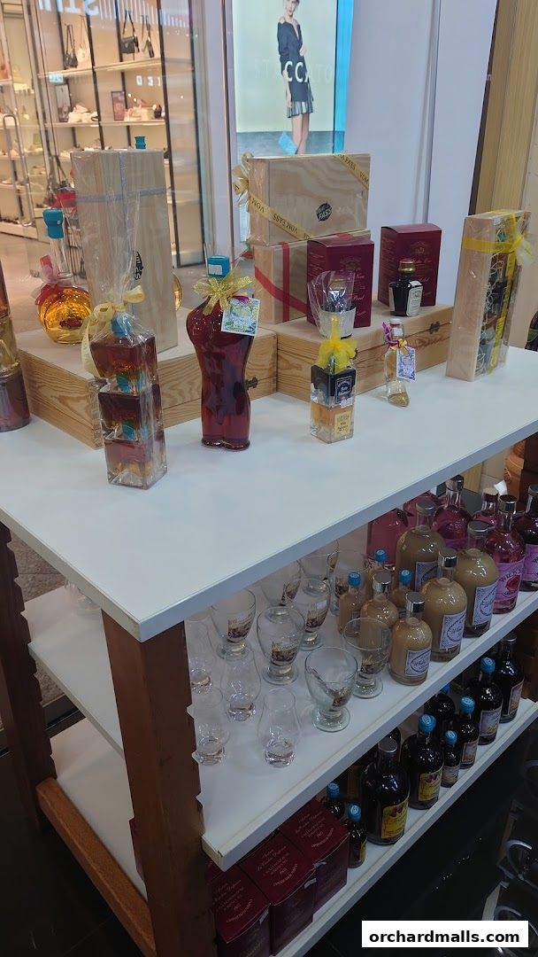 A display of bottled spirits and glassware in a retail shop.