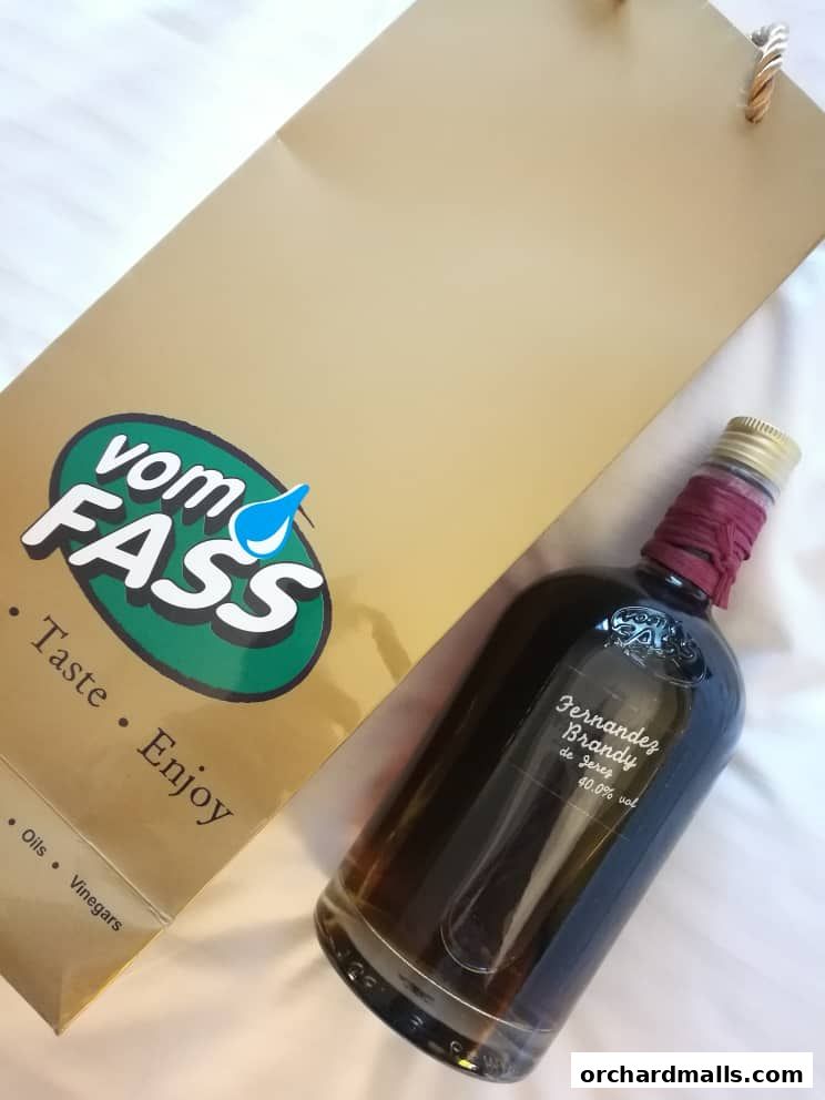 A bottle of Fernandez Brandy next to a Vom Fass shopping bag.