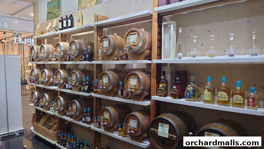 A shop interior displaying numerous wooden barrels and bottles of spirits and liqueurs.