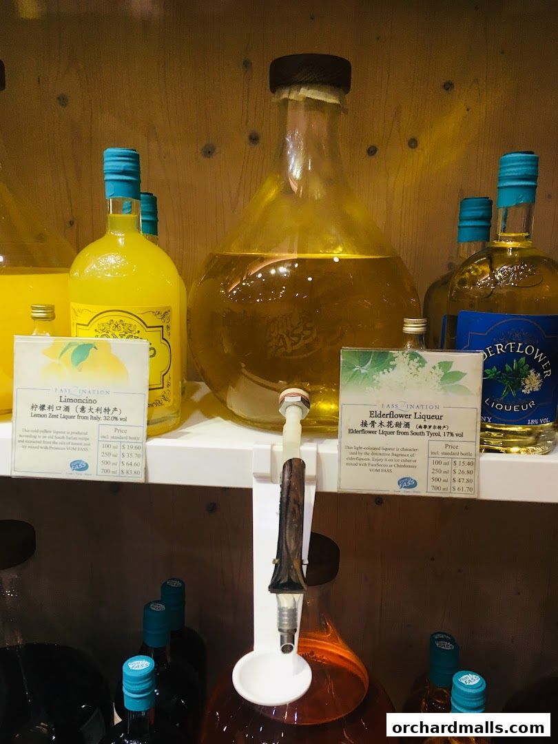 Bottles of Limoncino and Elderflower Liqueur displayed with dispensers.