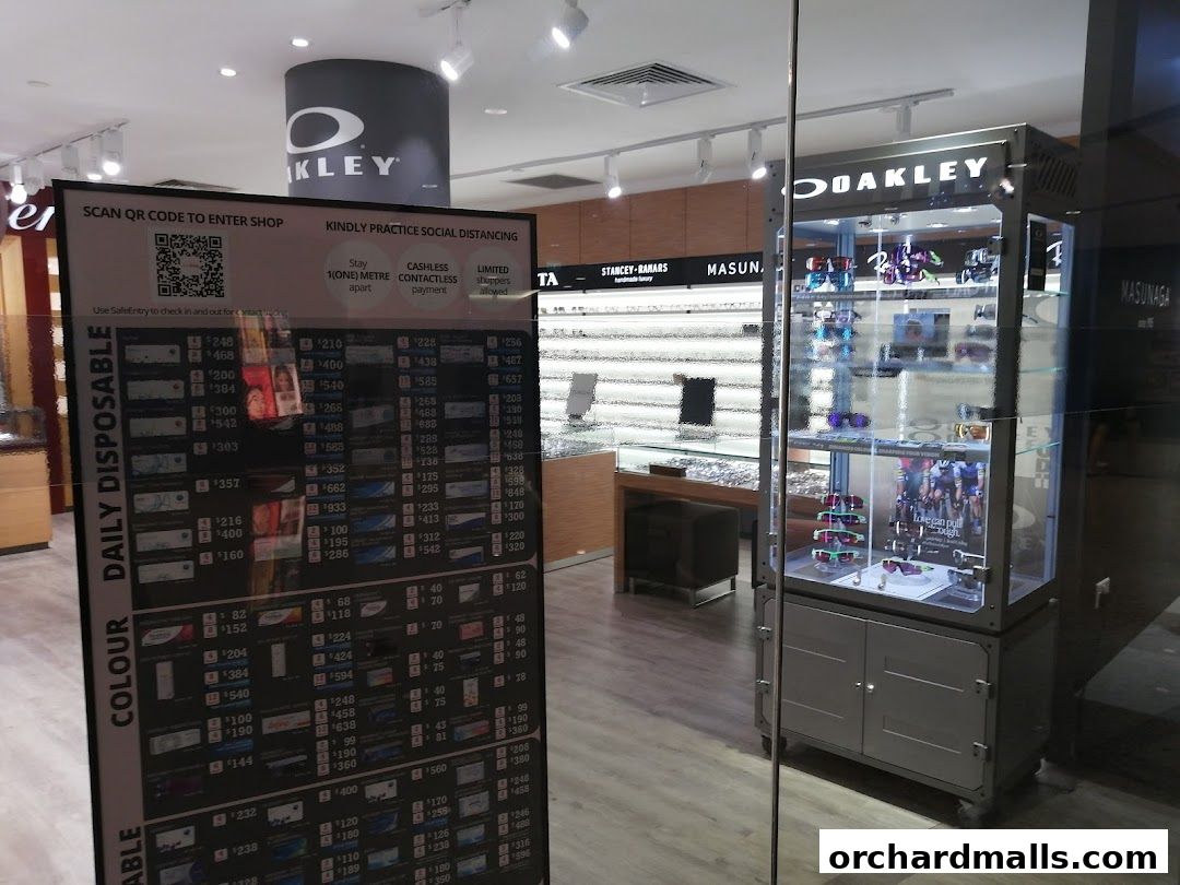 Interior view of W Optics shop with Oakley display and price list.