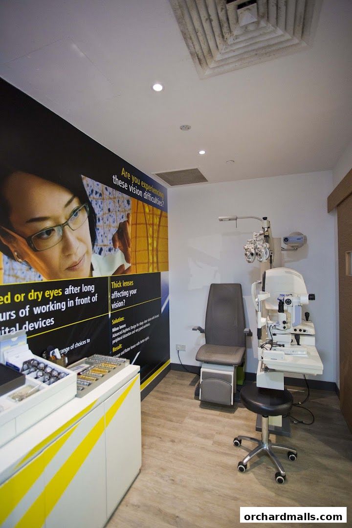 Interior of an optical shop with an eye examination chair and equipment.