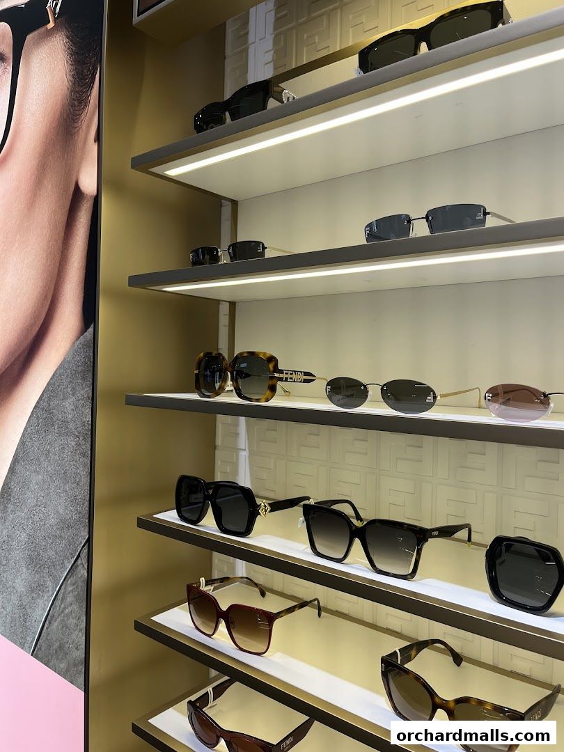 A display of various designer sunglasses on shelves, with a large advertisement on the left.