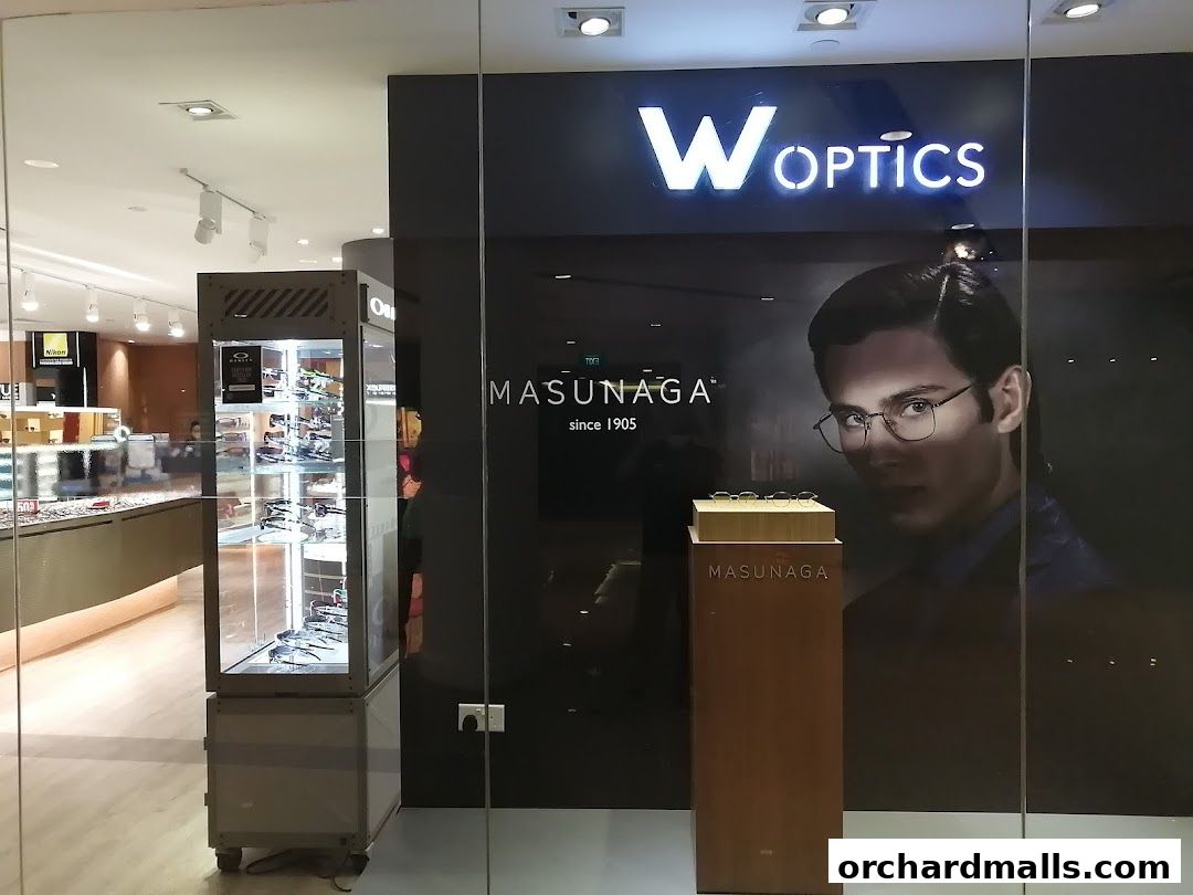 The exterior of W Optics, an eyewear store, showcasing various glasses and a model wearing spectacles.