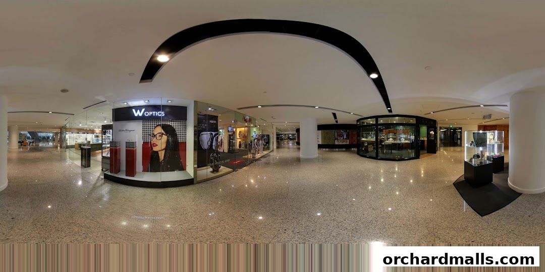 A panoramic view of the W Optics store and surrounding mall area.