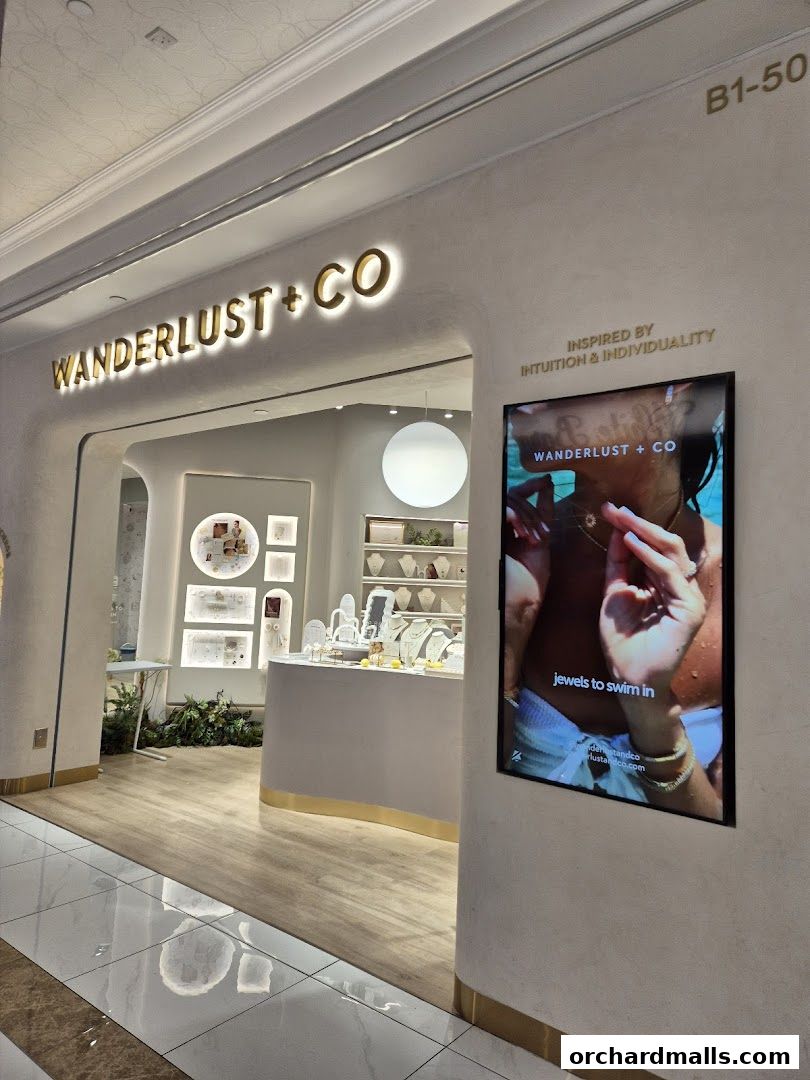 The entrance of Wanderlust + Co jewelry store with a digital display.