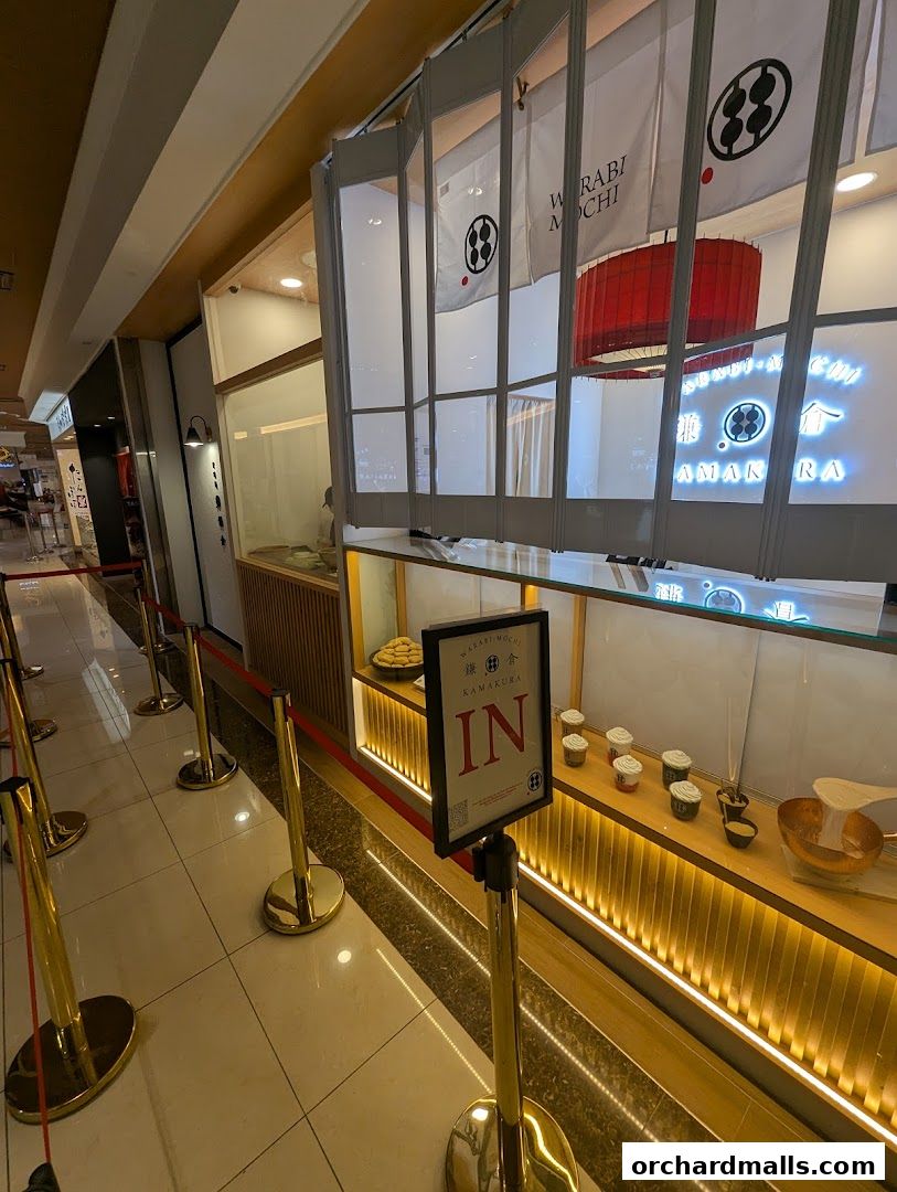 The entrance to Warabimochi Kamakura, a shop with a clean, modern aesthetic and a queue management system.